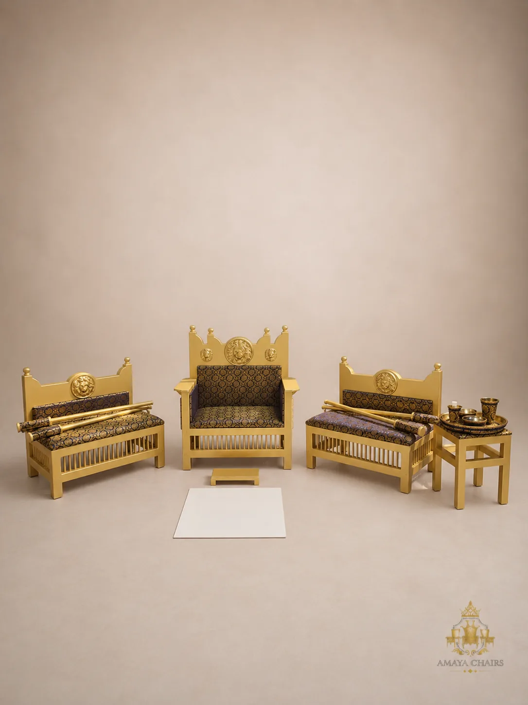 The Majestic Lion Maiyan suite on an ivory backdrop: gold frames topped with sculpted lion heads and a crown-shaped back, upholstered in a dark gold-and-black brocade.