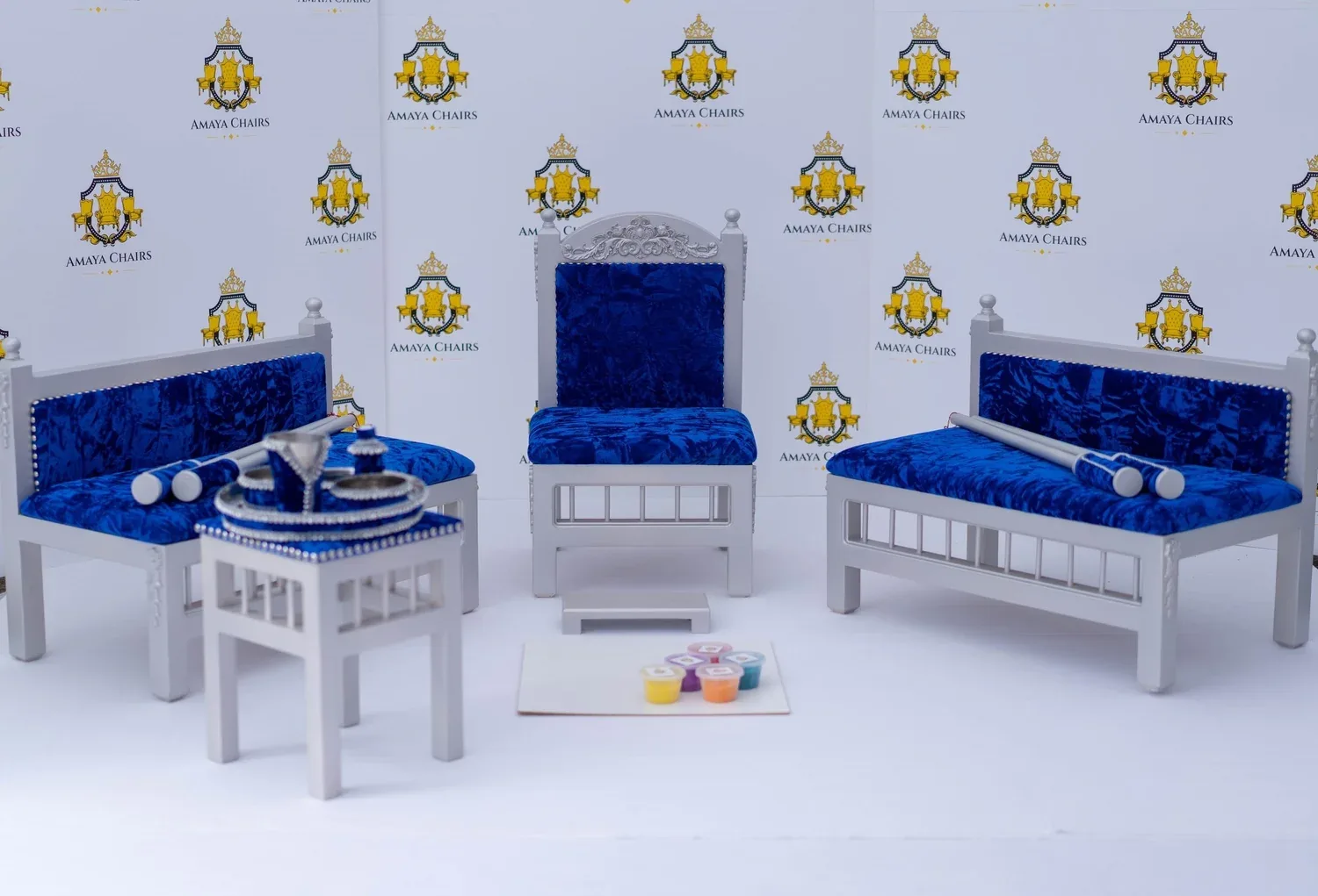 The full Blue Prince suite photographed in the workshop: head chair, both benches, tray table and the rangoli board laid out.