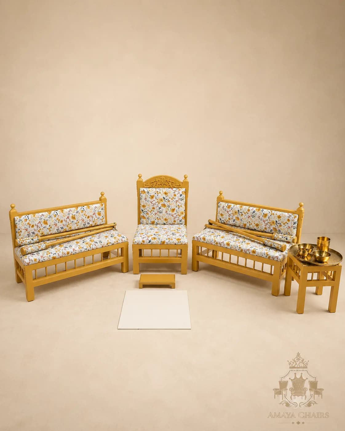 A bespoke Maiyan suite in honey-gold frames with a fine white ditsy floral upholstery, photographed on the warm studio backdrop.
